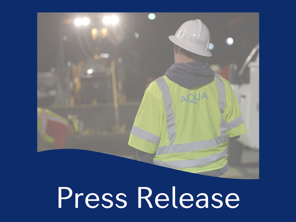 Construction worker wearing an AQUA safety vest and hard hat, with the text 'Press Release' at the bottom of the image.