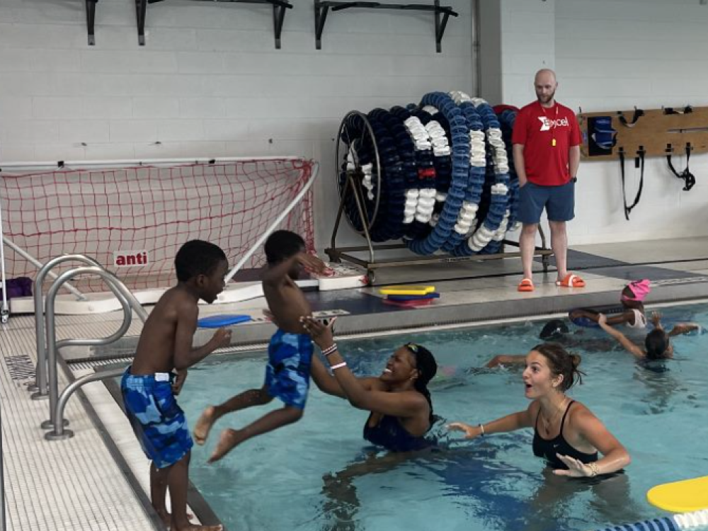 sure splash kids and adults in a pool